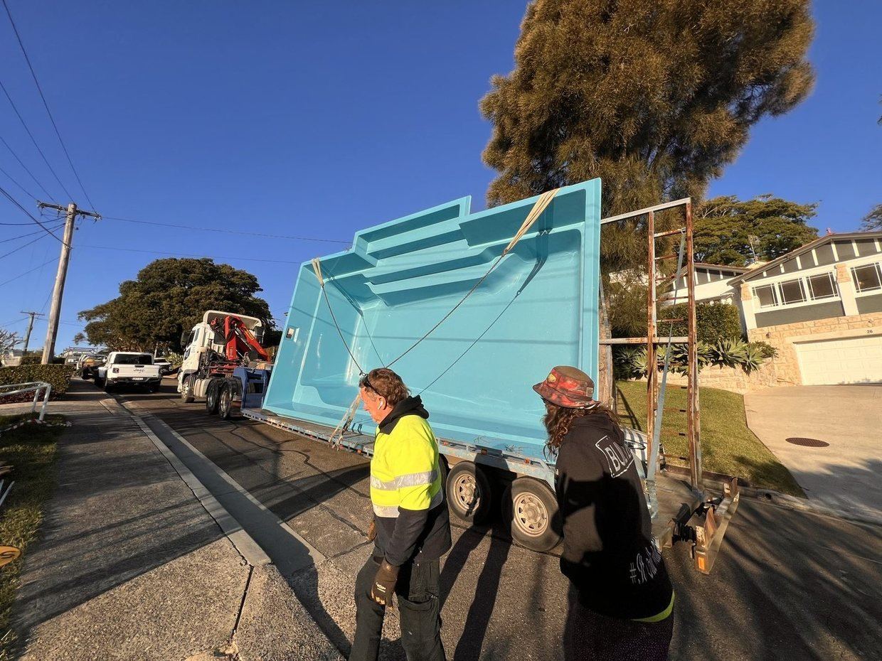 A fibreglass pool shell arriving on the trailer on delivery day